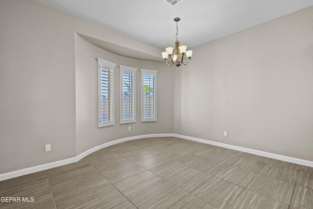 unfurnished room with a chandelier