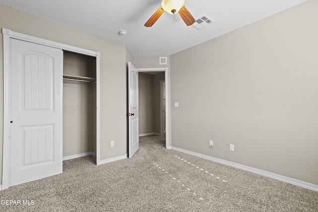 unfurnished bedroom with ceiling fan, a closet, and carpet floors