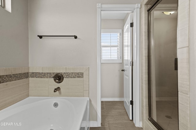 bathroom with separate shower and tub