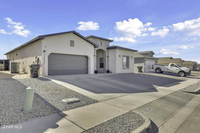 view of front of property featuring central AC and a garage