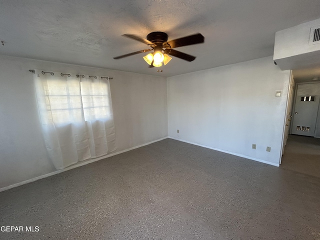 unfurnished room featuring ceiling fan and a textured ceiling