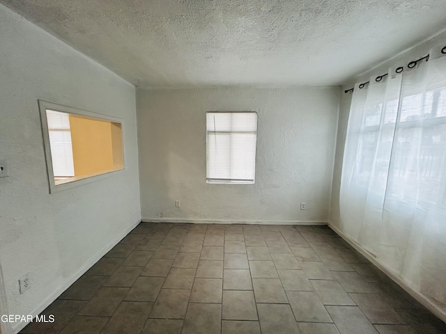 empty room featuring a textured ceiling