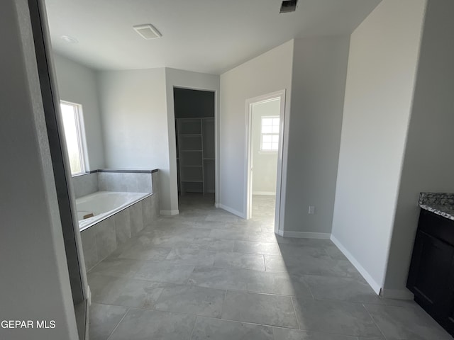 12498 Paseo Azul Dr, El Paso, TX 79928 - full bath featuring a bath, vanity, visible vents, a walk in closet, and baseboards