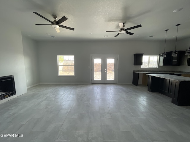 12498 Paseo Azul Dr, El Paso, TX 79928 - unfurnished living room with baseboards and a ceiling fan