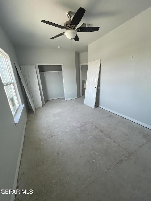 12498 Paseo Azul Dr, El Paso, TX 79928 - unfurnished bedroom with a closet, baseboards, ceiling fan, and unfinished concrete floors