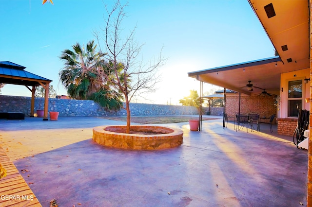 view of patio with ceiling fan and a gazebo