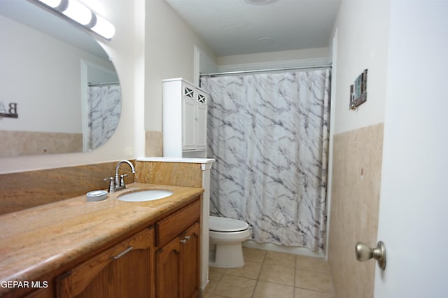 bathroom with toilet, vanity, tile patterned flooring, and walk in shower