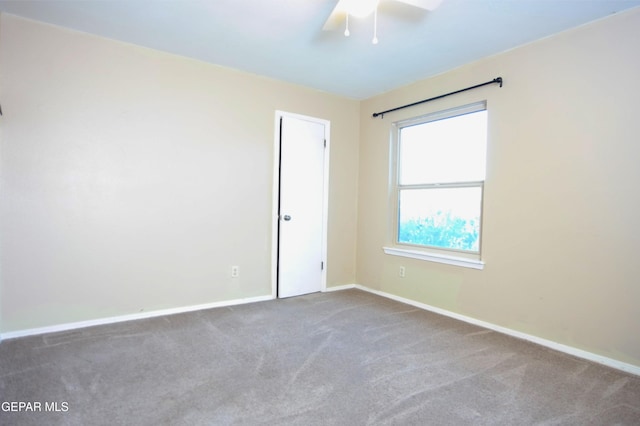 empty room with ceiling fan and carpet