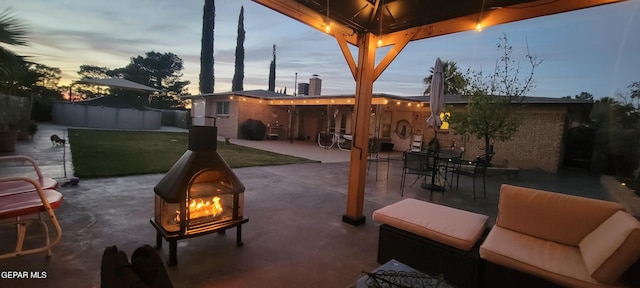 patio terrace at dusk with a gazebo and a lawn