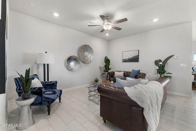 living room with ceiling fan and light hardwood / wood-style flooring