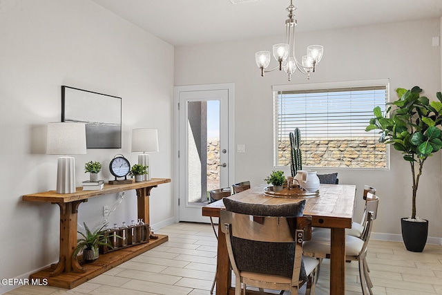 dining space with plenty of natural light, a chandelier, and light wood-type flooring