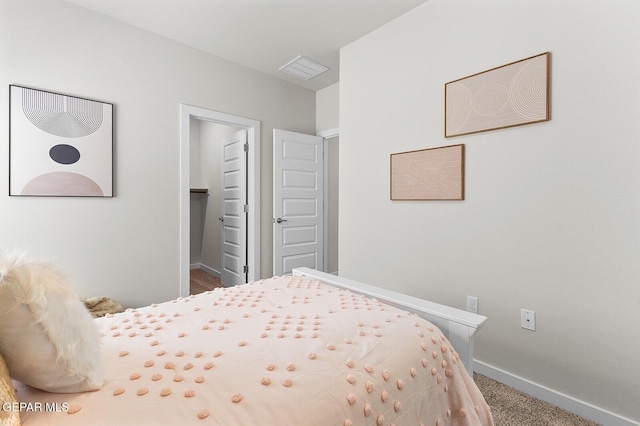 carpeted bedroom with a spacious closet