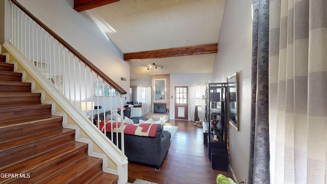 living room featuring high vaulted ceiling, a textured ceiling, dark hardwood / wood-style floors, and beam ceiling