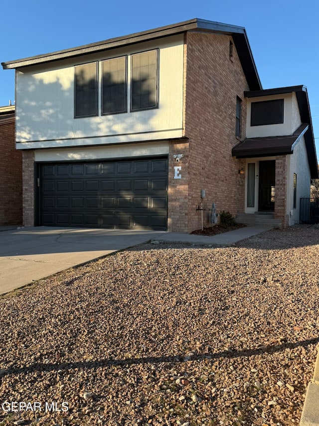 view of front of home with central AC unit and a garage