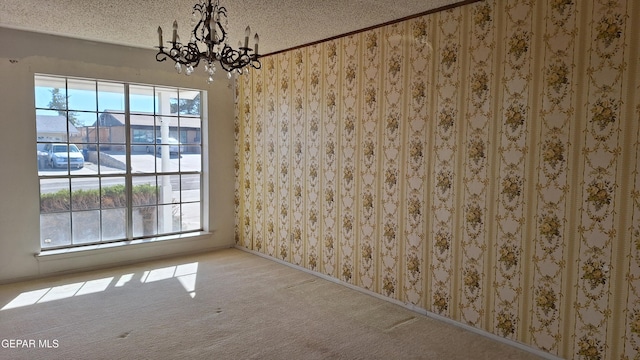 unfurnished dining area featuring light colored carpet, a textured ceiling, and an inviting chandelier