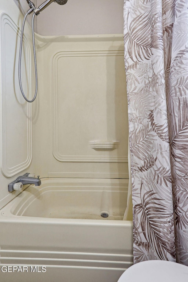 bathroom featuring toilet and a shower with shower curtain