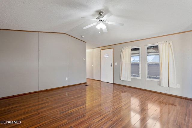 spare room featuring lofted ceiling, ceiling fan, dark hardwood / wood-style floors, and ornamental molding