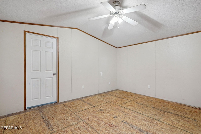 interior space with a textured ceiling, ceiling fan, and lofted ceiling