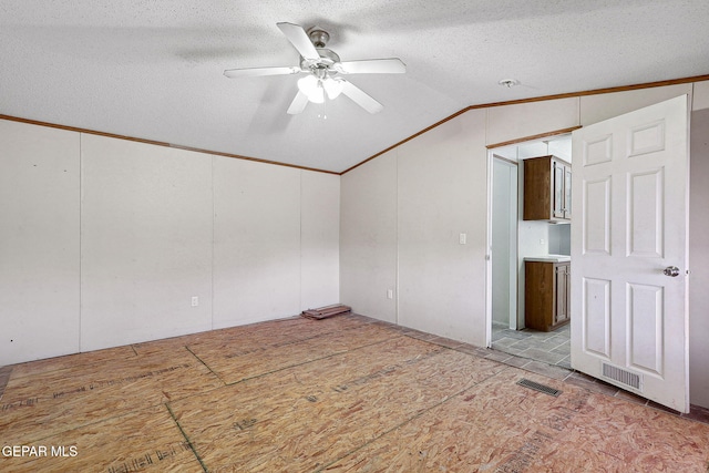 unfurnished room with a textured ceiling, ceiling fan, and lofted ceiling