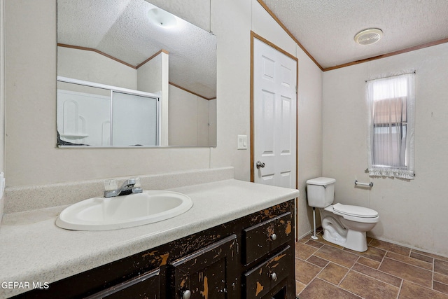 bathroom featuring vanity, toilet, lofted ceiling, and ornamental molding