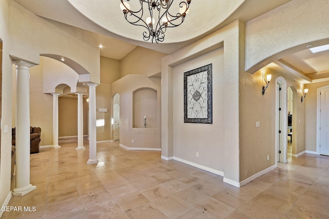 interior space with decorative columns and a chandelier