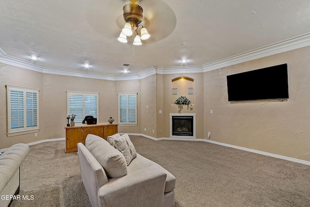 living room featuring ceiling fan, carpet floors, and ornamental molding