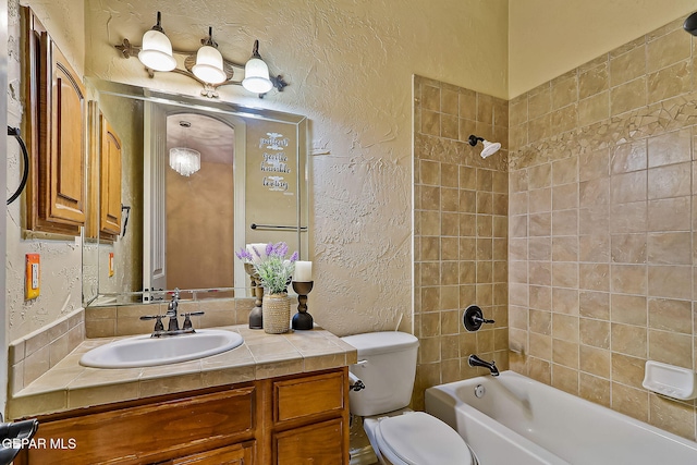 full bathroom featuring vanity, toilet, and tiled shower / bath