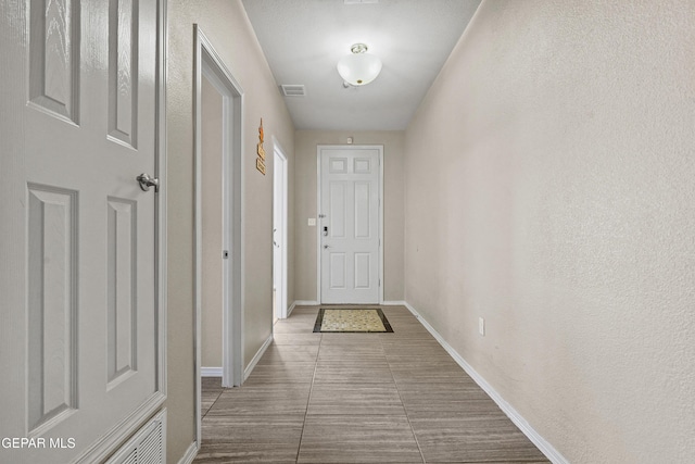 doorway to outside with tile patterned flooring