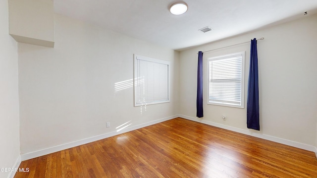 spare room with hardwood / wood-style floors