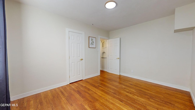 spare room featuring hardwood / wood-style flooring