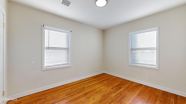 empty room with hardwood / wood-style floors