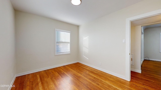 spare room with wood-type flooring