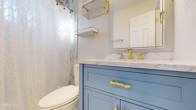 bathroom featuring vanity, toilet, and walk in shower