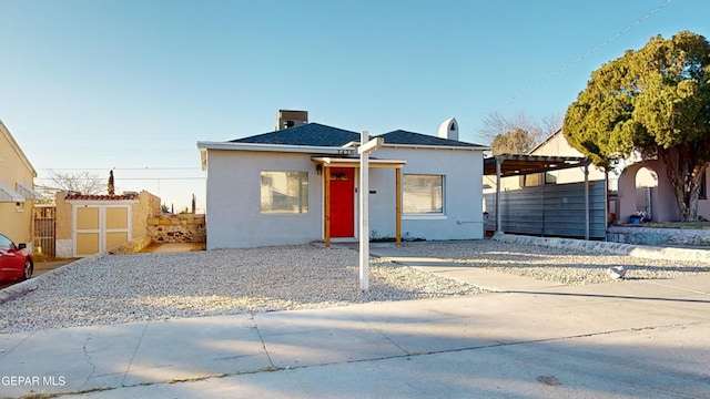 view of front of house with a shed and a carport