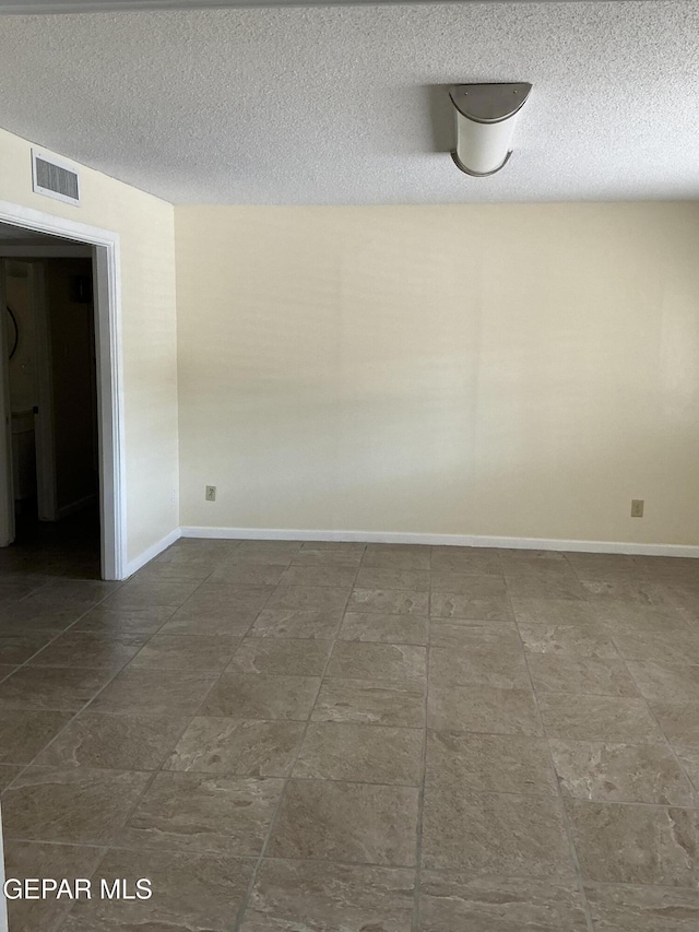 empty room featuring a textured ceiling