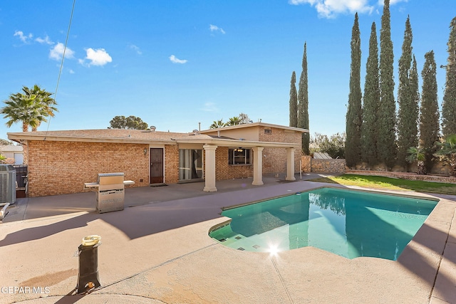 view of swimming pool featuring cooling unit and a patio area