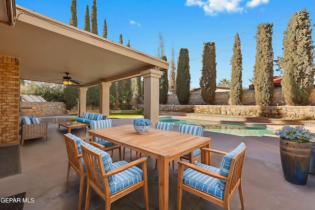 view of patio with an outdoor living space and ceiling fan