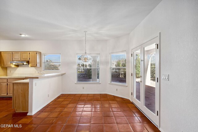 unfurnished dining area with dark tile patterned floors