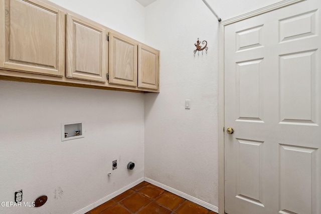 laundry room featuring cabinets, washer hookup, hookup for an electric dryer, dark tile patterned floors, and gas dryer hookup