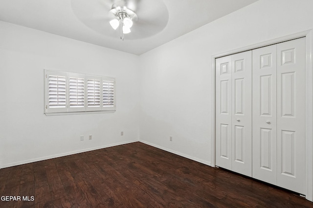 unfurnished bedroom featuring ceiling fan, a closet, and dark hardwood / wood-style floors