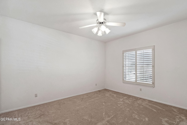 carpeted empty room featuring ceiling fan