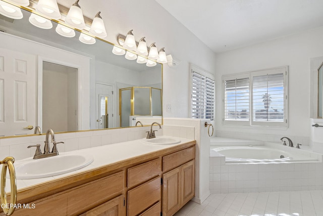 bathroom with tile patterned flooring, vanity, and shower with separate bathtub