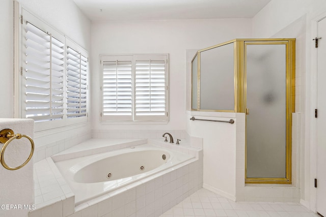 bathroom with tile patterned floors and shower with separate bathtub