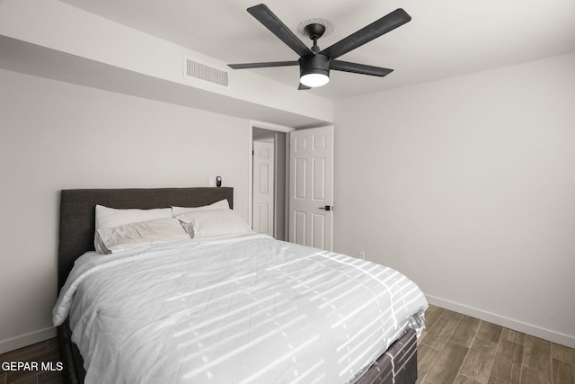 bedroom with visible vents, ceiling fan, baseboards, and wood finished floors