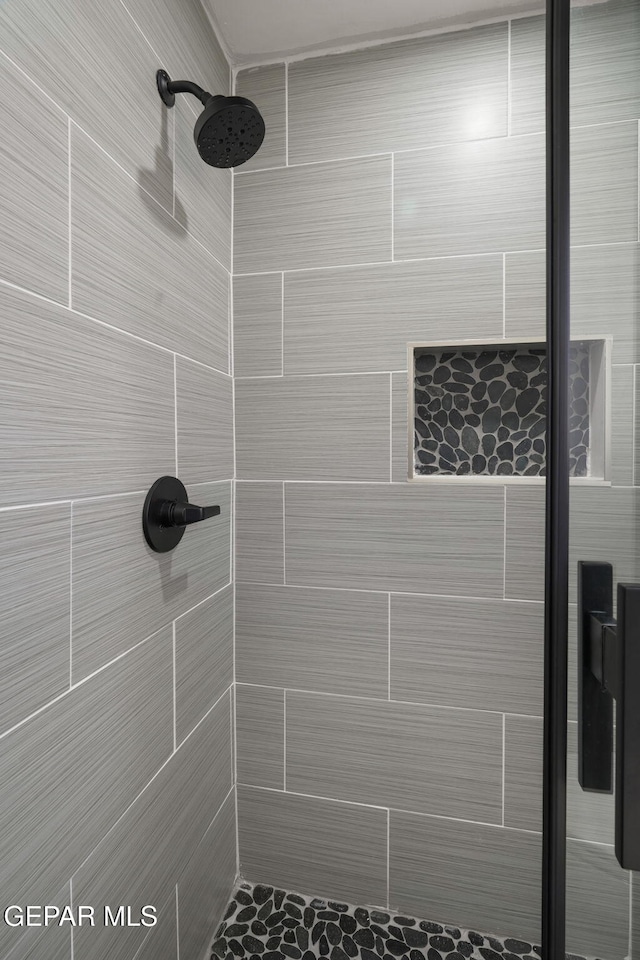 bathroom with tiled shower