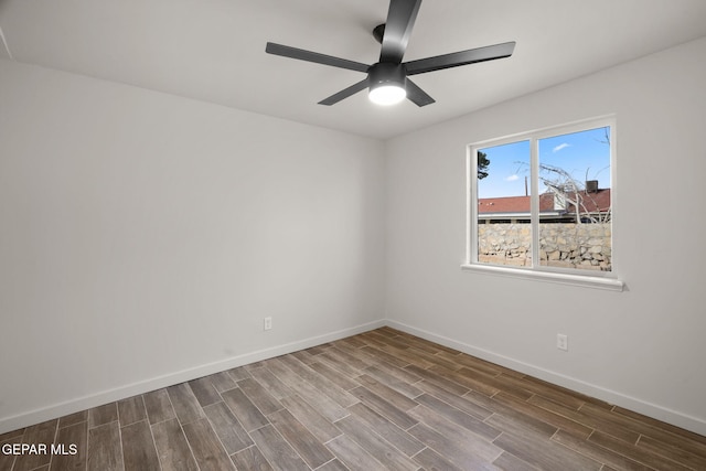 unfurnished room featuring ceiling fan, baseboards, and wood finish floors