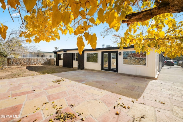 exterior space featuring a patio area, fence, and french doors