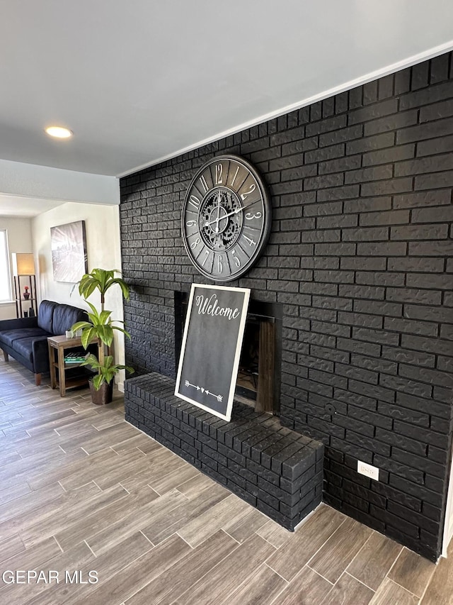 welcome area featuring a brick fireplace