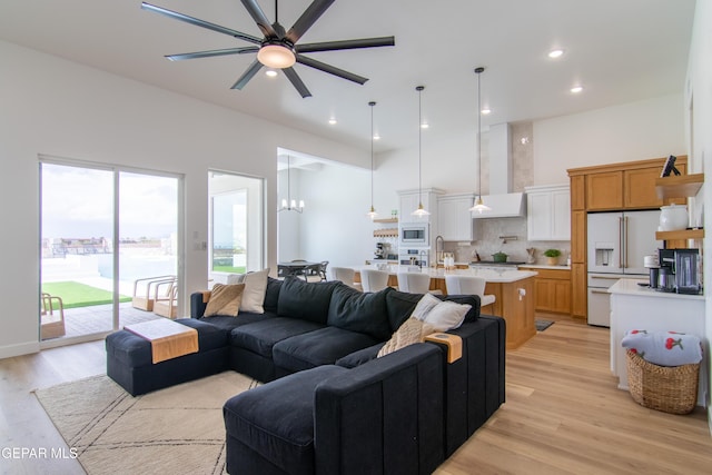 living room featuring ceiling fan and light hardwood / wood-style flooring