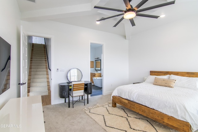 carpeted bedroom featuring beamed ceiling, ceiling fan, and ensuite bath